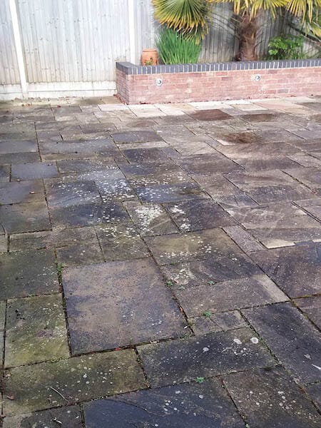 Dirty and stained patio surface before cleaning