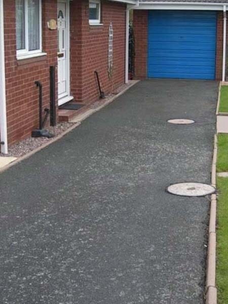 Dirty and stained tarmac driveway